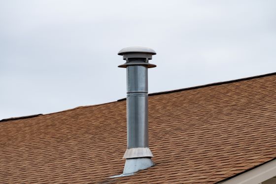 Close-up of pipe chimney on brown roof