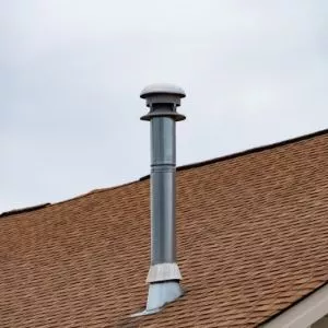 Close-up of pipe chimney on brown roof